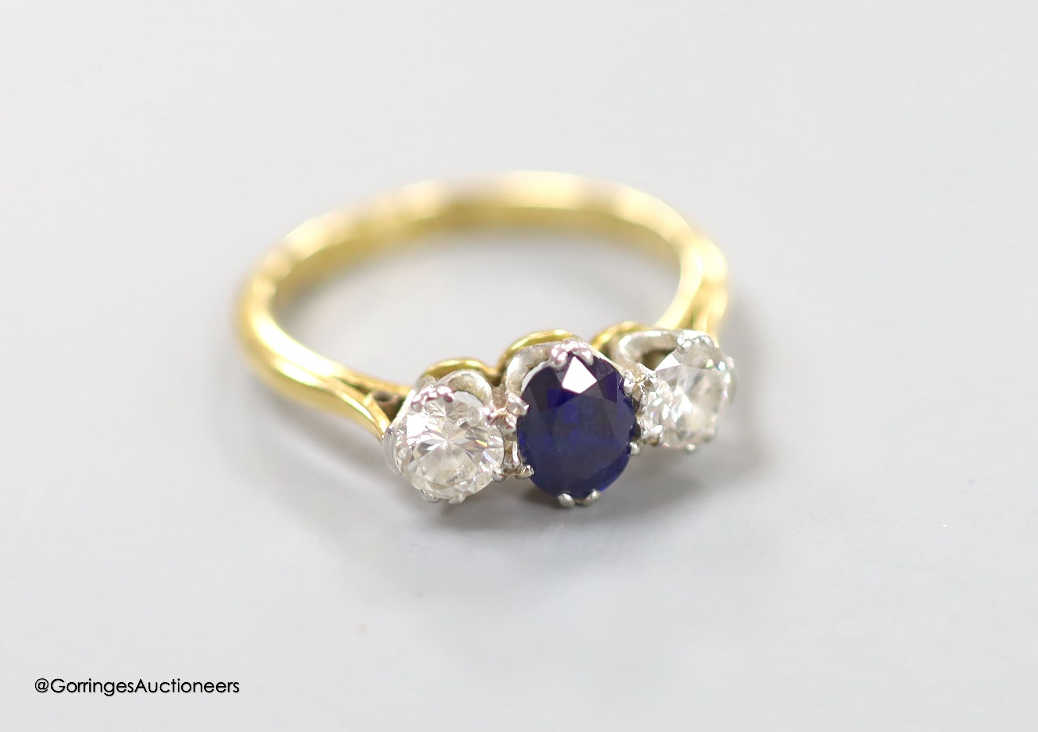 An 18ct & plat, sapphire and diamond three stone ring, size O, gross weight 3.4 grams